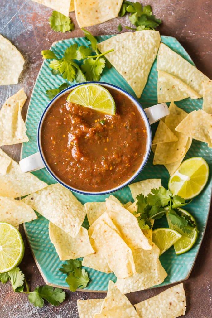 overhead shot of homemade salsa in a bowl surrounded by chips