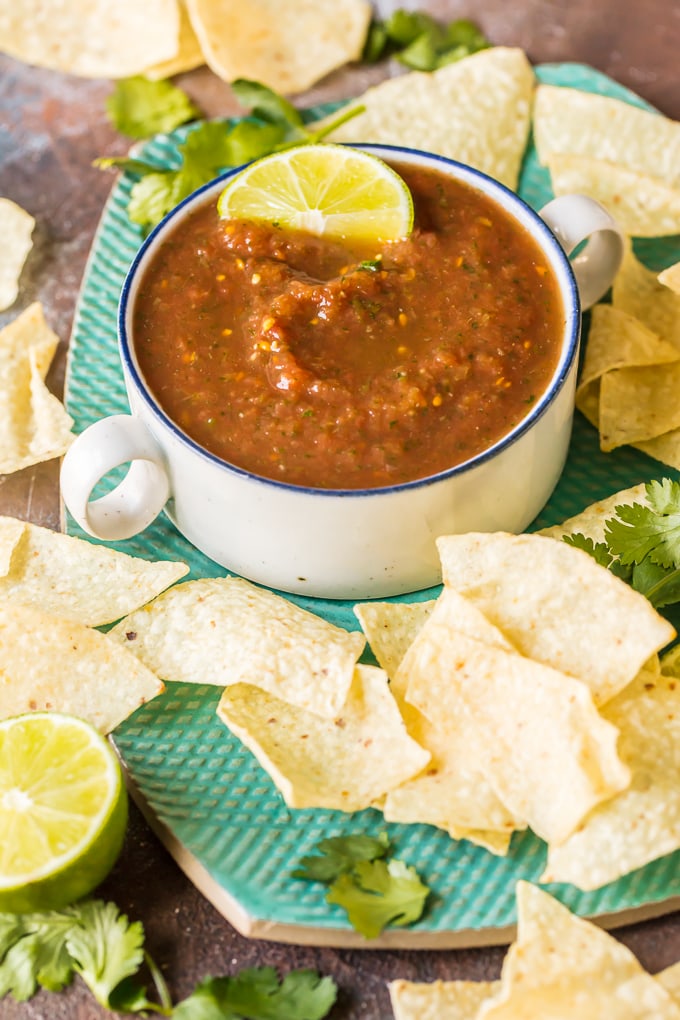 Blender Salsa is the absolute best EASY Homemade Salsa Recipe you'll ever make. Chips and Salsa are a must for Cinco de Mayo and this is our favorite Easy Salsa Recipe. This Homemade Salsa has SO much flavor and has just the perfect amount of heat. Perfect for tailgating!