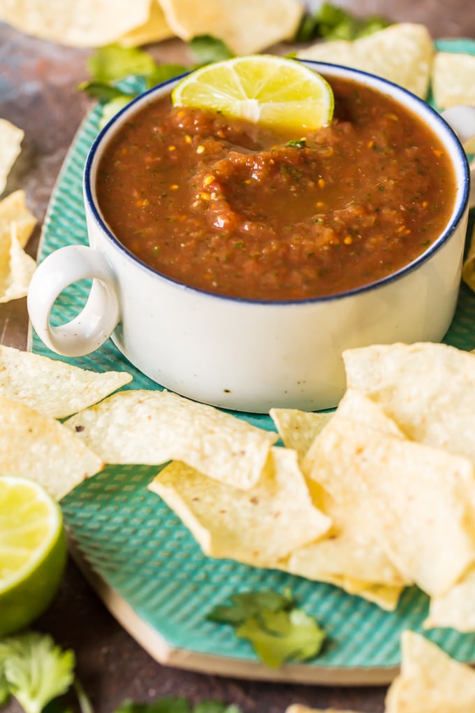 Blender Salsa is the absolute best EASY Homemade Salsa Recipe you'll ever make. Chips and Salsa are a must for Cinco de Mayo and this is our favorite Easy Salsa Recipe. This Homemade Salsa has SO much flavor and has just the perfect amount of heat. Perfect for tailgating!