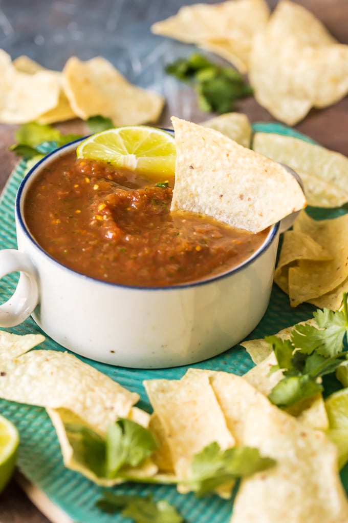 Blender Salsa is the absolute best EASY Homemade Salsa Recipe you'll ever make. Chips and Salsa are a must for Cinco de Mayo and this is our favorite Easy Salsa Recipe. This Homemade Salsa has SO much flavor and has just the perfect amount of heat. Perfect for tailgating!