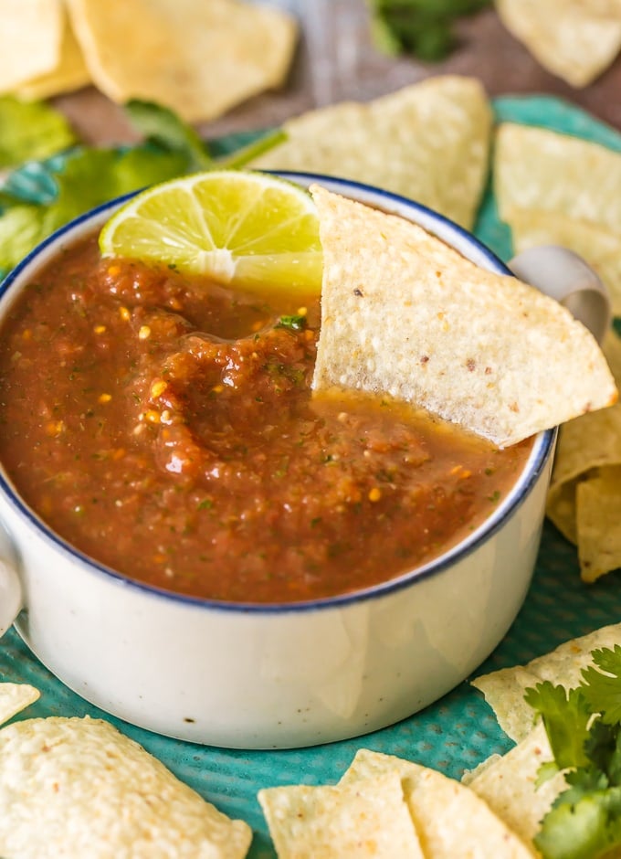 dipping a chip in homemade salsa