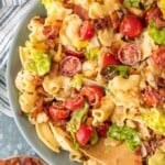 blt pasta salad in a bowl with wooden spoon
