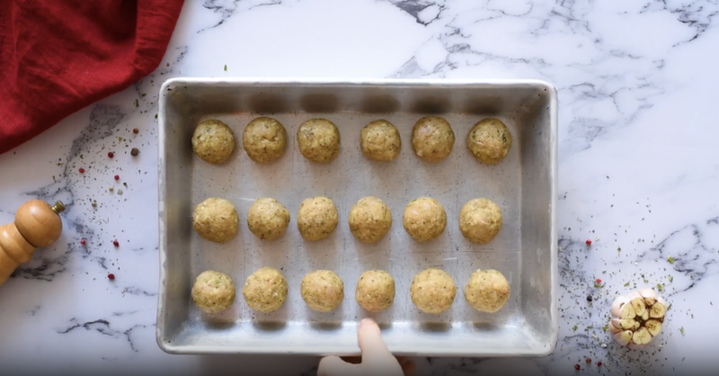 18 chicken meatballs on. a baking sheet.