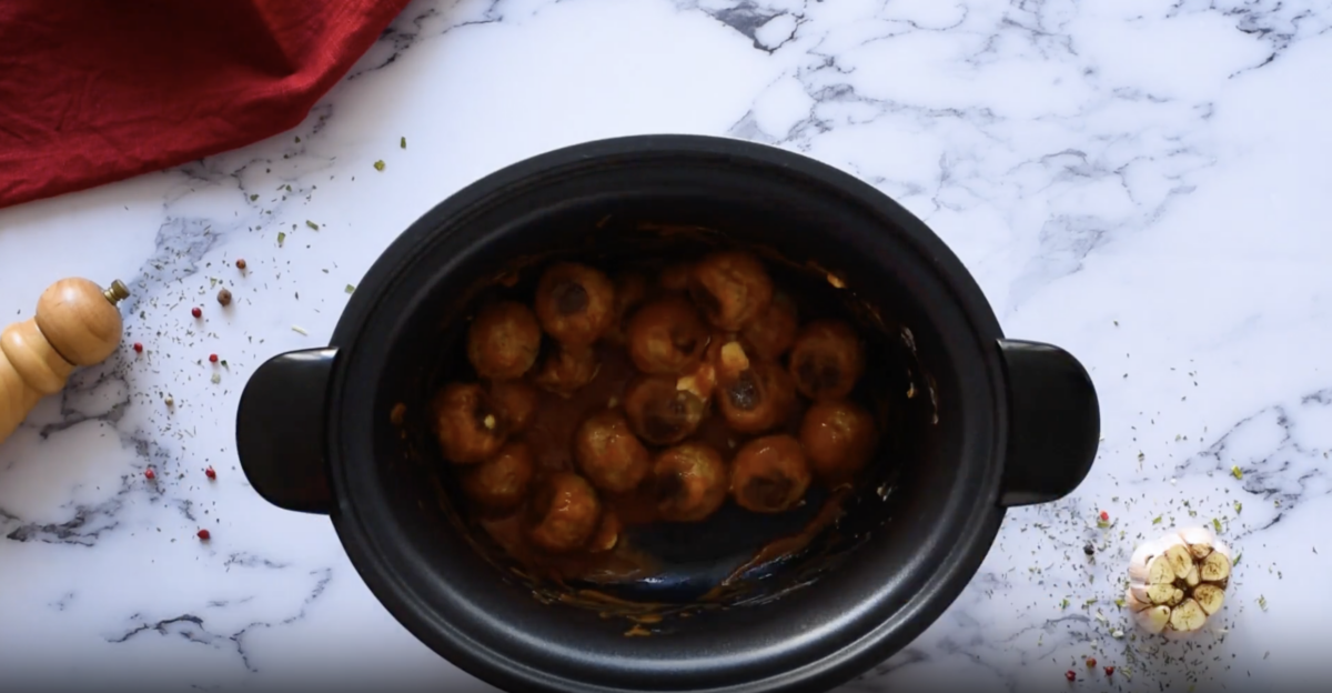 Buffalo chicken meatballs in a crockpot.