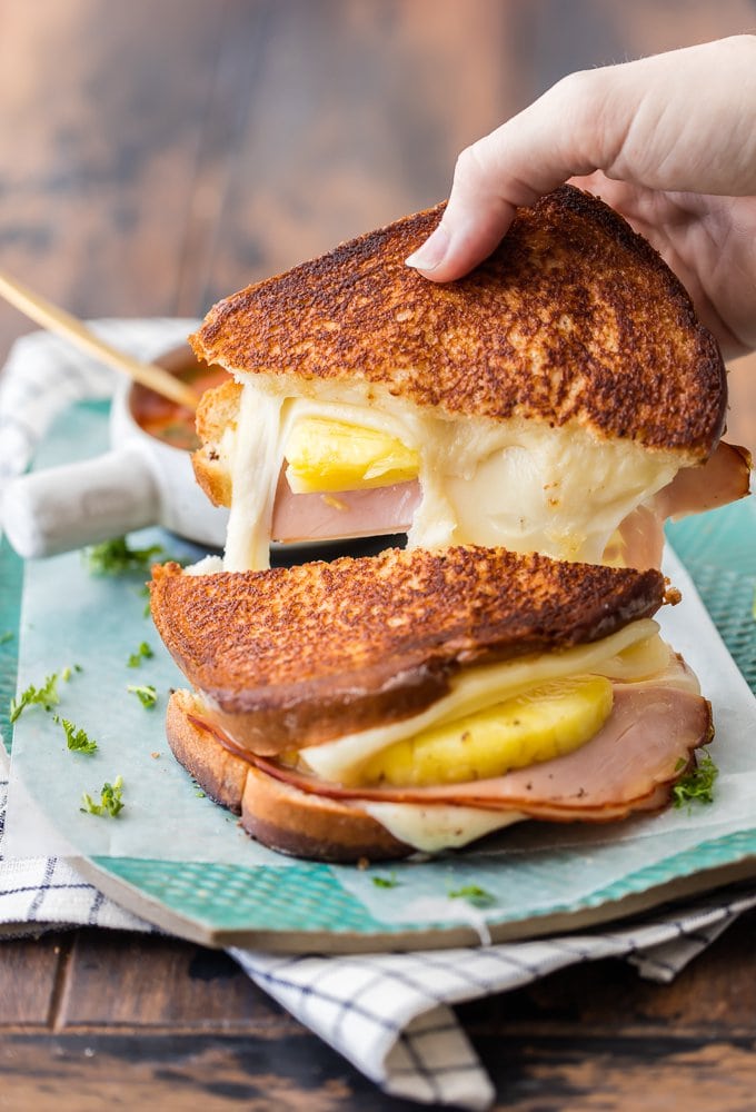 hand grabbing a piece of grilled cheese