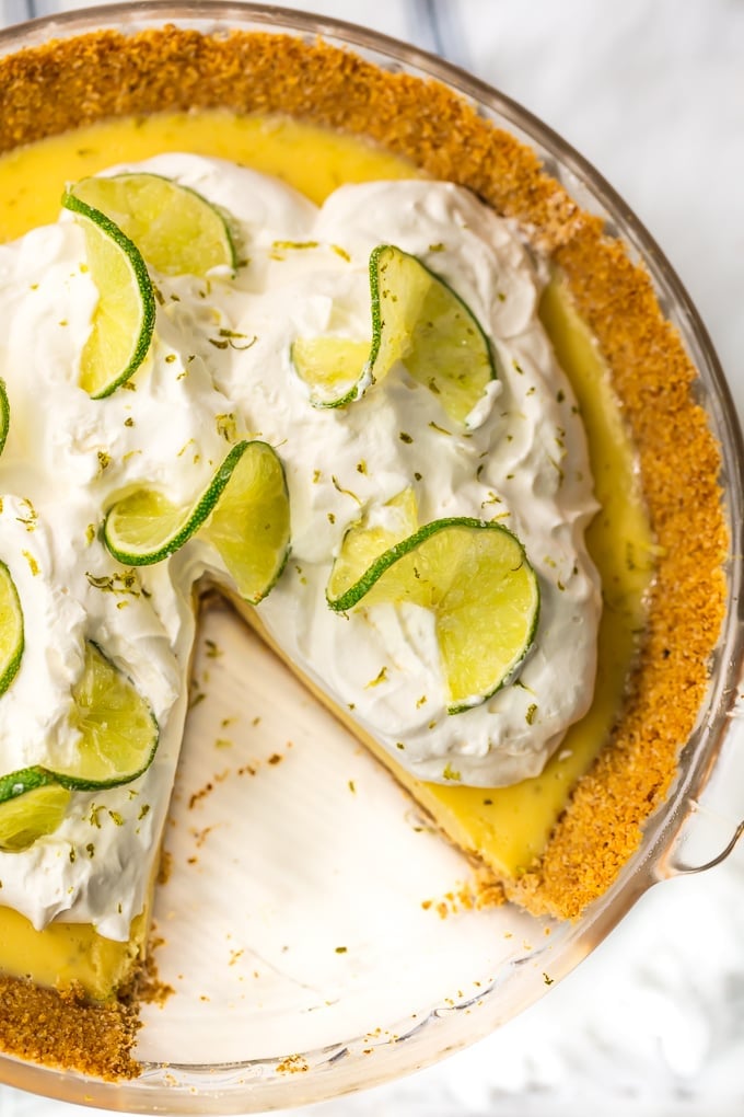 over the top view of a key lime pie with a slice cut out