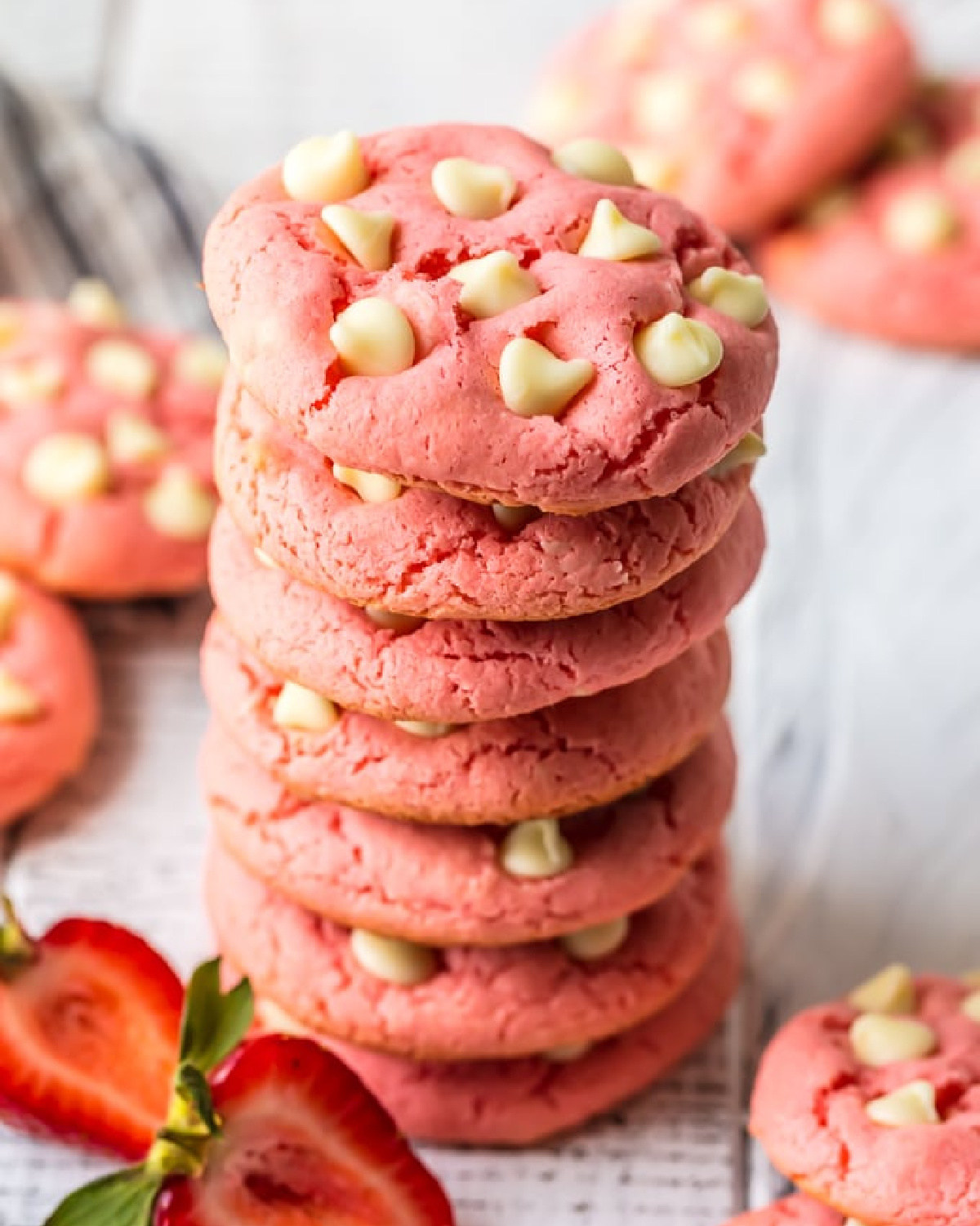 A stack of strawberry cake mix cookies with white chocolate chips.