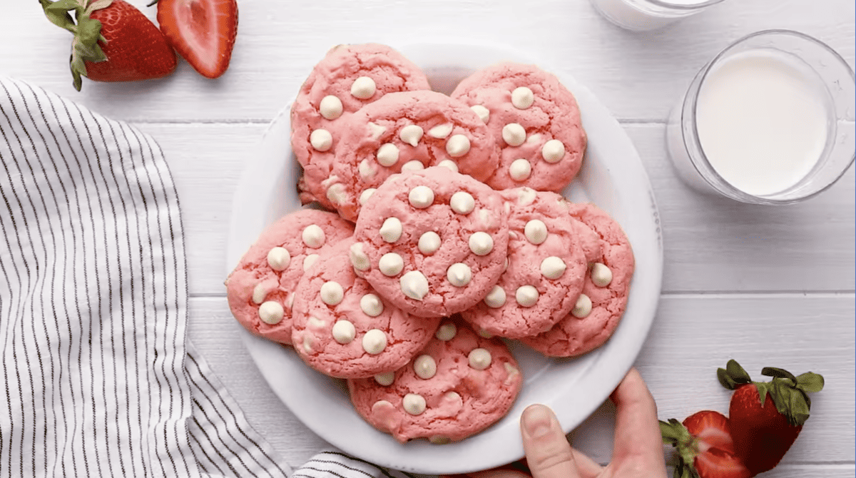 A plate of strawberry cake mix cookies with white chocolate chips.