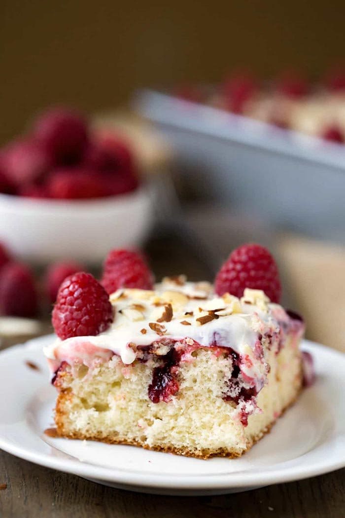 White Raspberry Poke Cake | I Heart Eating Poke Cake Recipes are a favorite at our house. There's nothing better than a Jello Poke Cake Recipe to make a celebration unique, tasty, and most importantly EASY! These 10 Pudding Poke Cake Recipes are simple. creamy, flavorful, and creative. Enjoy!