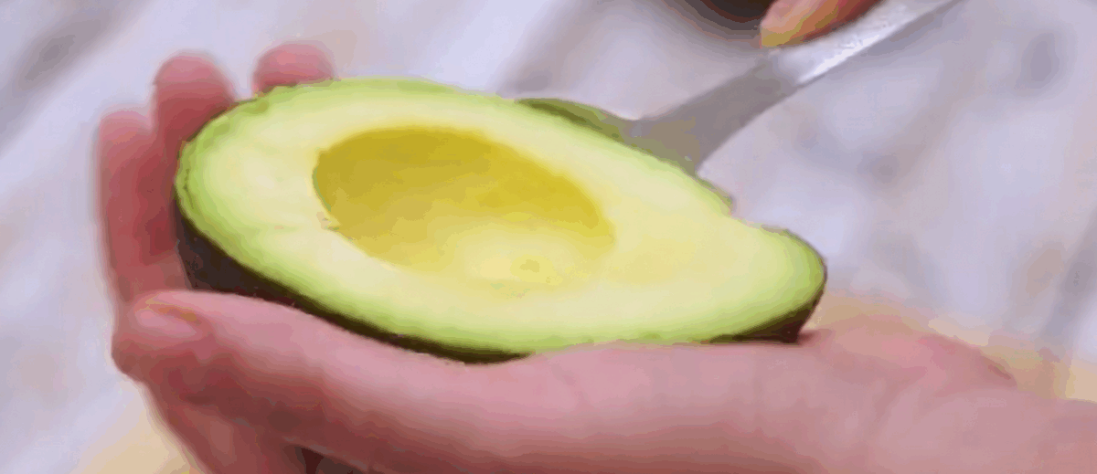 Scooping out an avocado.