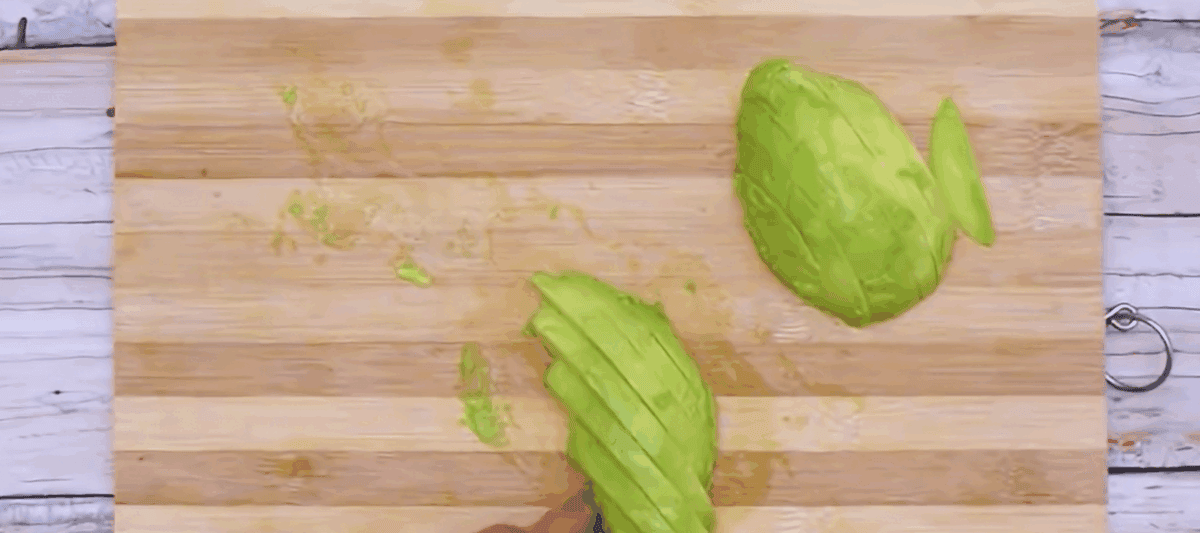 Slicing an avocado into fries. 