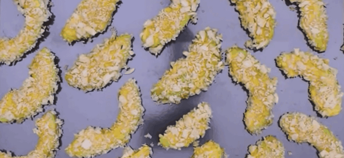 Avocado fries on a baking sheet. 