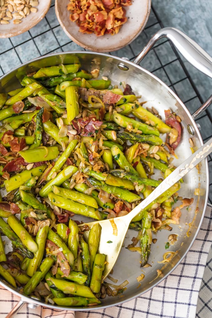 A pan filled with chopped asparagus and sliced pancetta
