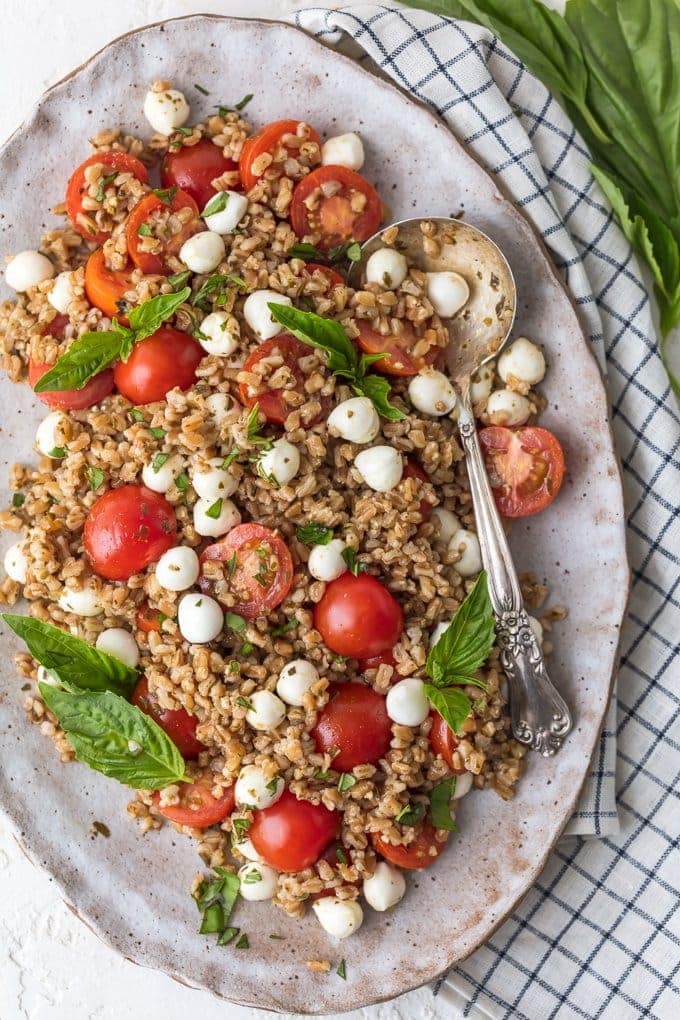 Caprese Farro Salad on a large platter with spoon