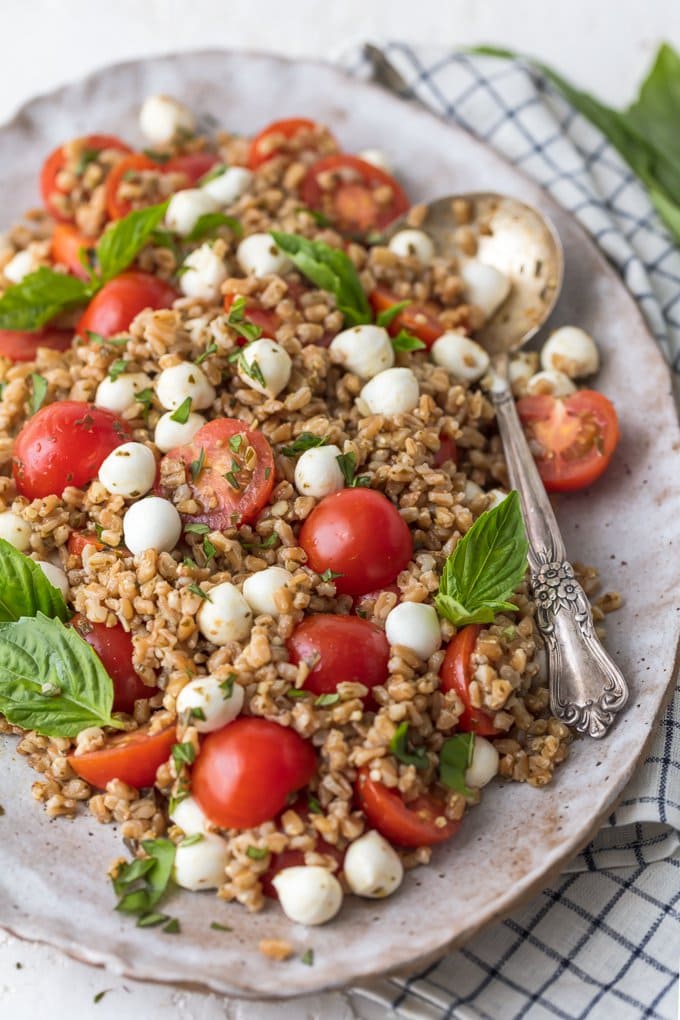 Caprese Farro Salad is a healthy side dish sure to please every member of the family. Caprese Salad with Farro is our favorite way to enjoy the best flavors; tomatoes, mozzarella, basil, and balsamic. Farro is such an easy and good for you grain to prepare and goes with just about any main dish. This Fresh Caprese Farro Salad Recipe is the perfect Summer Salad or meal!