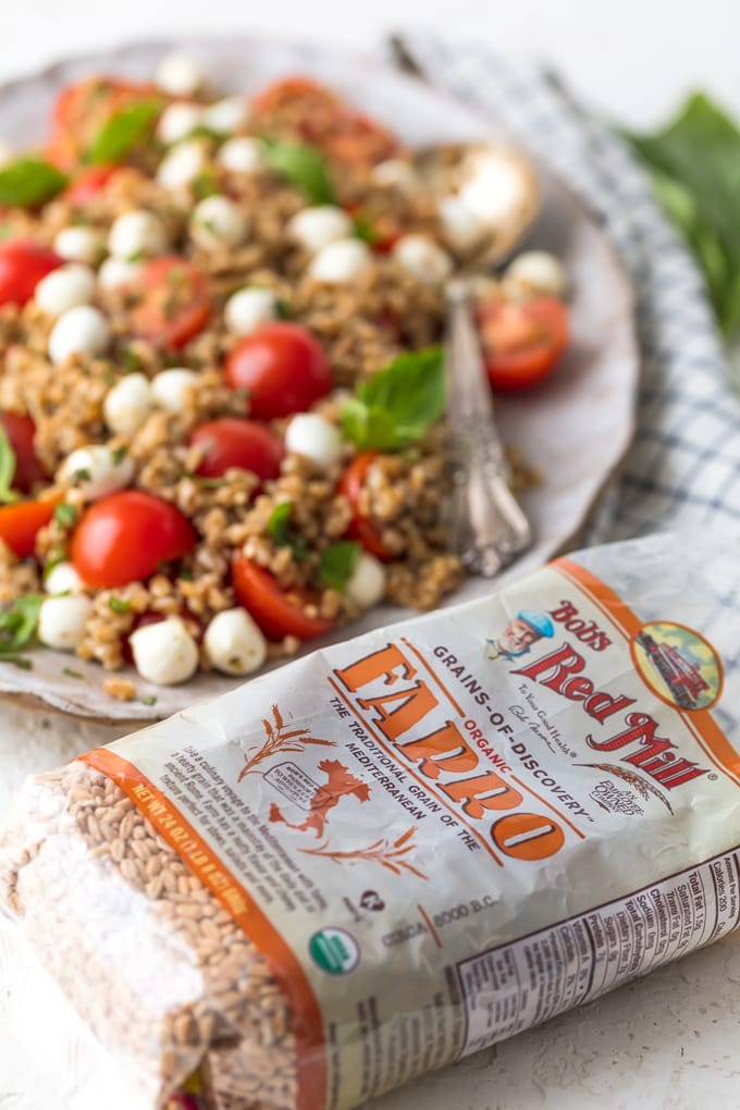 bag of farro in front of a salad