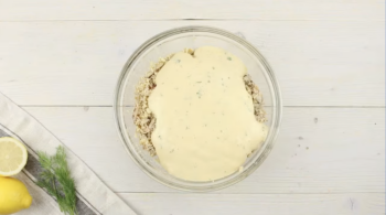 crab meat and mayonnaise in a glass bowl.