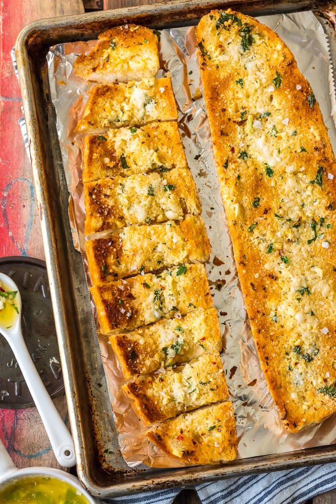 Homemade Garlic Bread is the absolute BEST Garlic Bread Recipe we have ever tried! If you want to learn How to Make Garlic Bread where the butter melts deep into the bread, creating the ultimate garlicky, carb filled side dish, you've come to the right place. We bake it, then broil it, to make it crispy on the outside while staying soft and buttery on the inside.