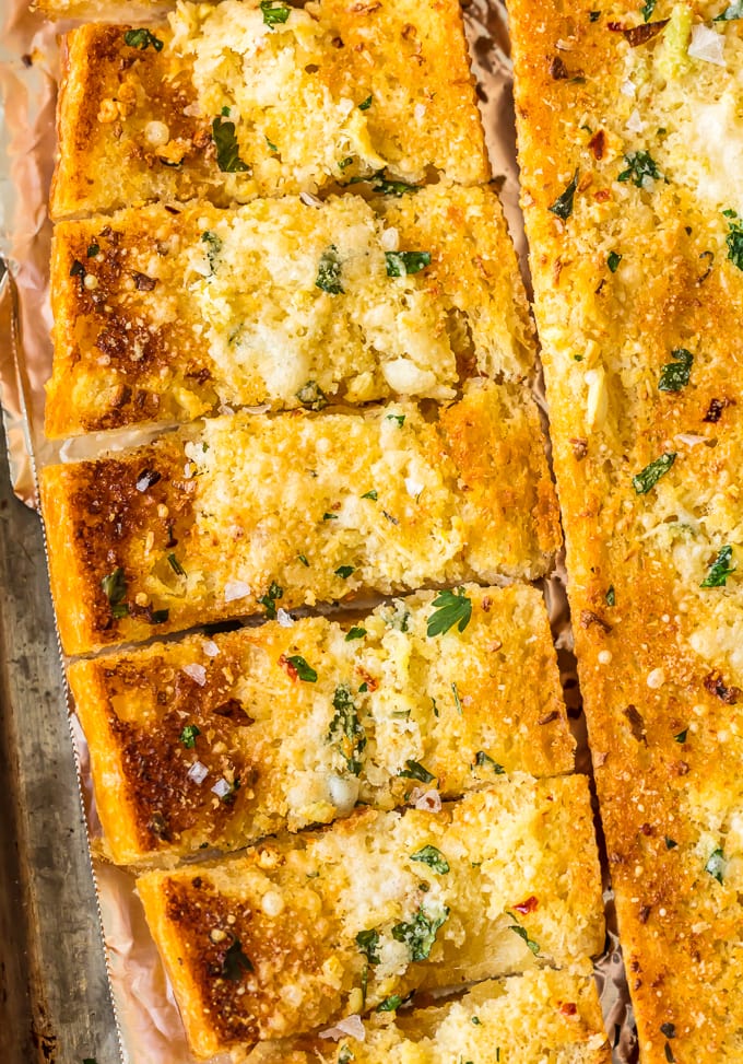 Homemade Garlic Bread is the absolute BEST Garlic Bread Recipe we have ever tried! If you want to learn How to Make Garlic Bread where the butter melts deep into the bread, creating the ultimate garlicky, carb filled side dish, you've come to the right place. We bake it, then broil it, to make it crispy on the outside while staying soft and buttery on the inside.