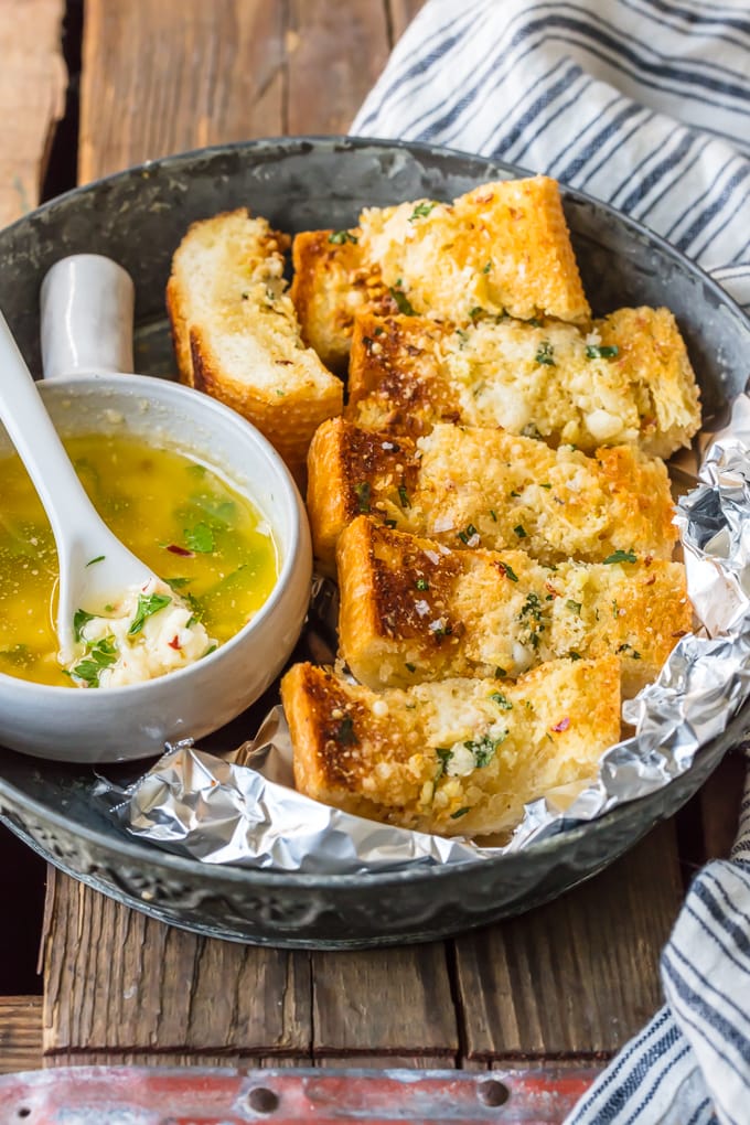 Homemade Garlic Bread is the absolute BEST Garlic Bread Recipe we have ever tried! If you want to learn How to Make Garlic Bread where the butter melts deep into the bread, creating the ultimate garlicky, carb filled side dish, you've come to the right place. We bake it, then broil it, to make it crispy on the outside while staying soft and buttery on the inside.