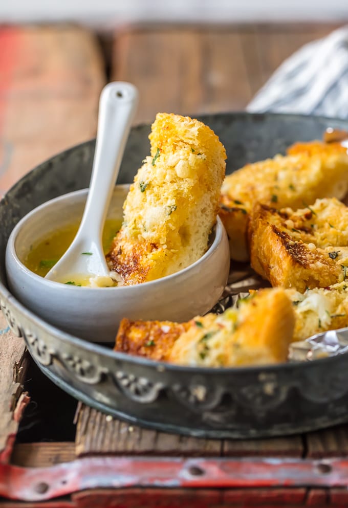 Homemade Garlic Bread is the absolute BEST Garlic Bread Recipe we have ever tried! If you want to learn How to Make Garlic Bread where the butter melts deep into the bread, creating the ultimate garlicky, carb filled side dish, you've come to the right place. We bake it, then broil it, to make it crispy on the outside while staying soft and buttery on the inside.