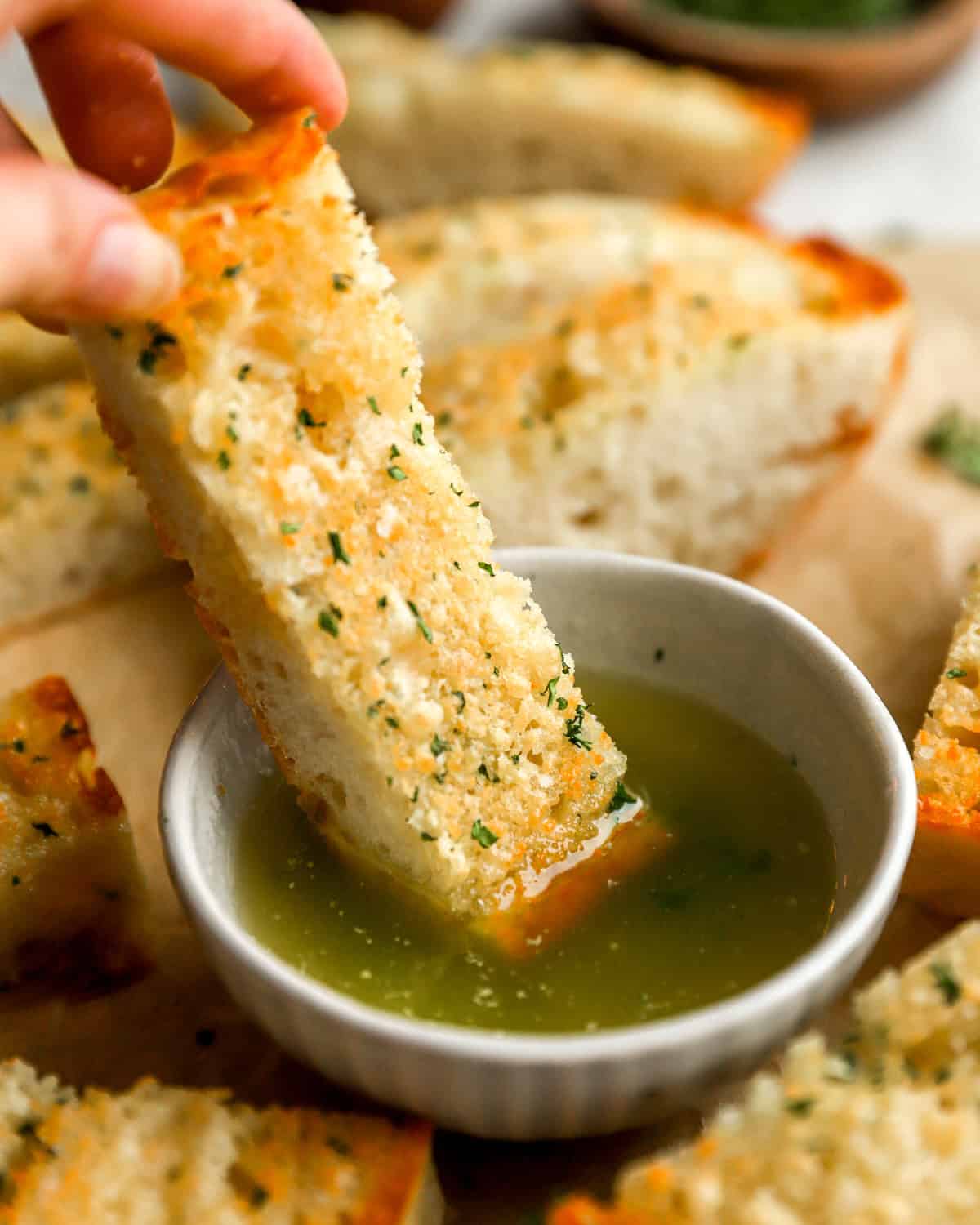 homemade garlic bread slice dipped in butter