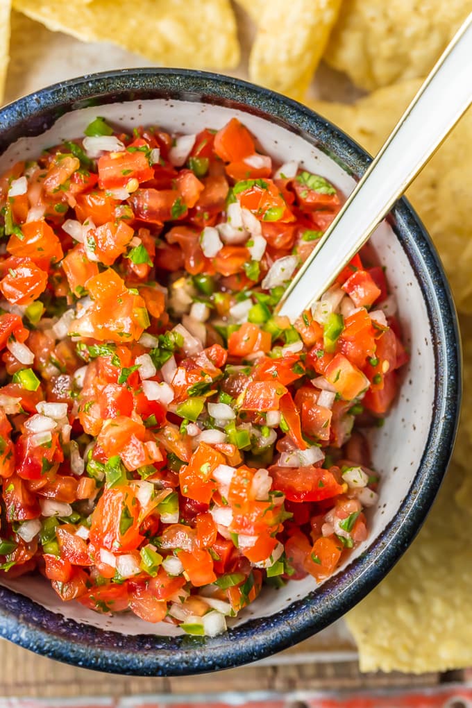 Homemade Pico de Gallo is a MUST MAKE for Summer and especially Cinco de Mayo. We love this EASY, quick, and flavorful Salsa Fresca that's loaded with fresh tomatoes, onion, garlic, lime juice, cilantro, and jalapeno peppers. This Pico de Gallo Recipe is the perfect topping for steak or chicken or is perfect for chips and salsa. Best recipe for Summer!