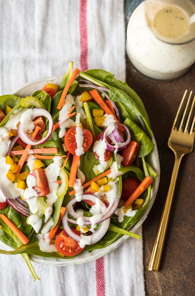 A colorful salad of greens and vegetables, drizzled with homemade ranch dressing