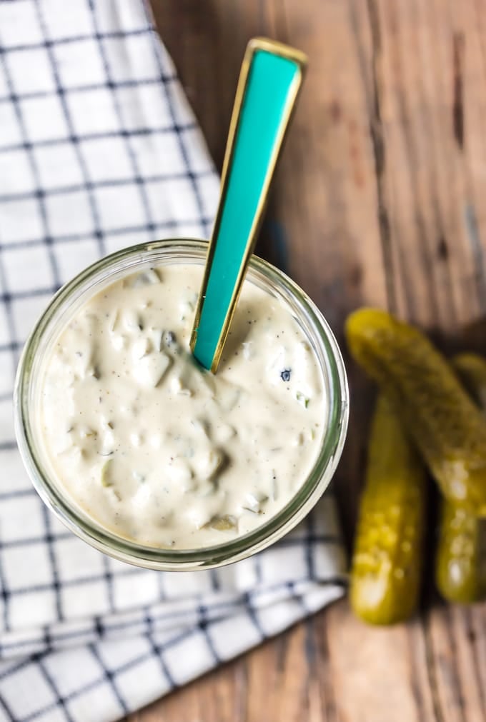 Teal spoon sitting in a jar of tartar sauce