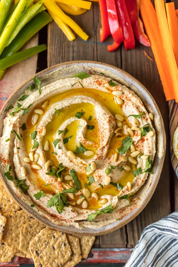 Sticks of vegetables next to a bowl of hummus
