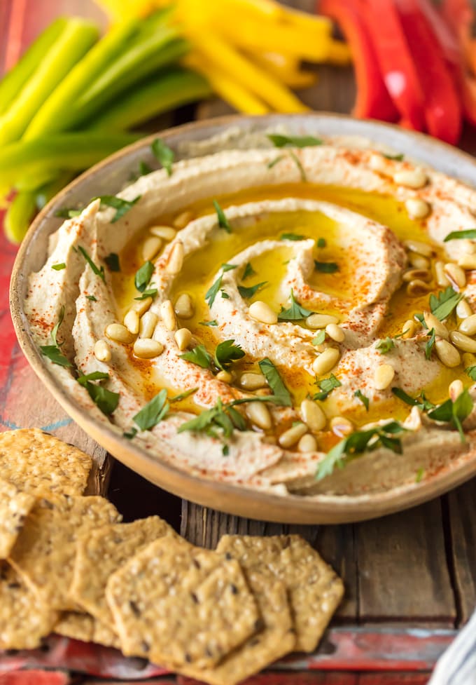 A bowl of hummus sprinkled with pine nuts