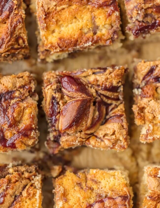 Peanut Butter and Jelly Cake Bars are a fun and kid-friendly recipe! These Peanut Butter and Jelly Bars make for a tasty dessert, a simple snack, or even an indulgent breakfast. I love putting a new spin on classic kid's food to make something creative and delicious for the whole family. You'll never think of Peanut Butter and Jelly the same once you've had these snack cakes!