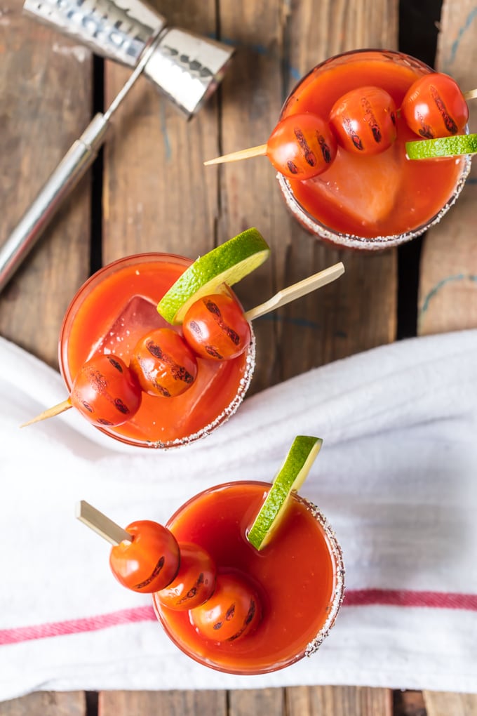 Roasted tomato margaritas with 3 tomatoes on top of each glass