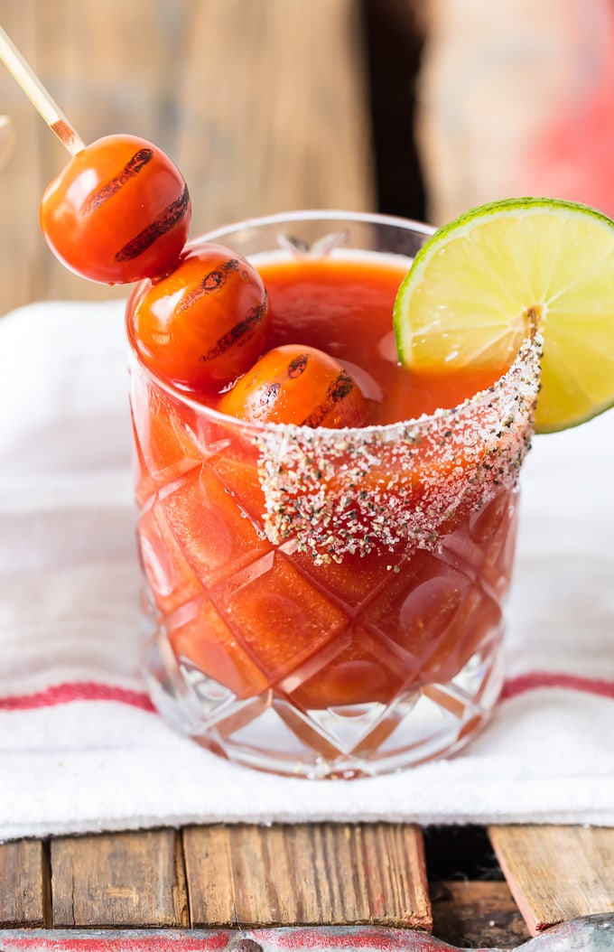 Roasted tomato margarita in a short glass with a salt and chili powder mix on the rim