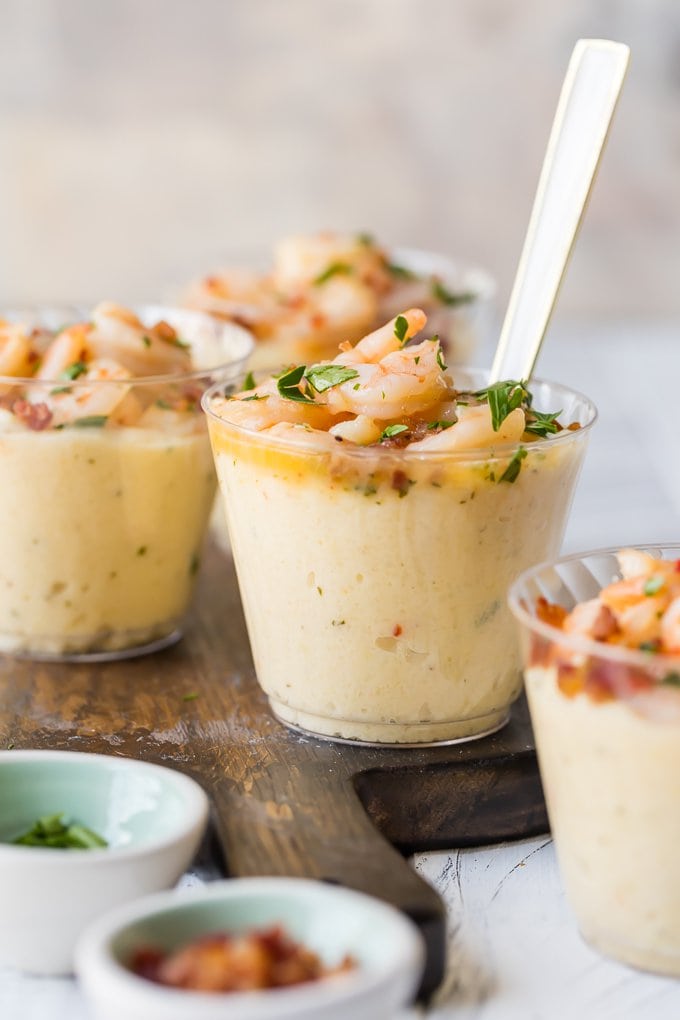 These Shrimp and Grits Appetizer Cups on a wooden cutting board