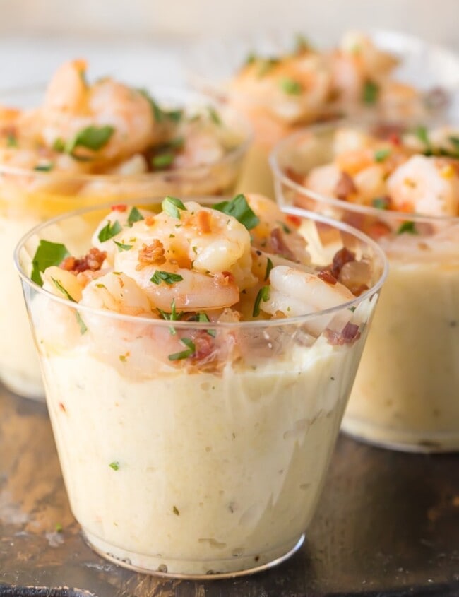 shrimp and grit cups on a wooden cutting board
