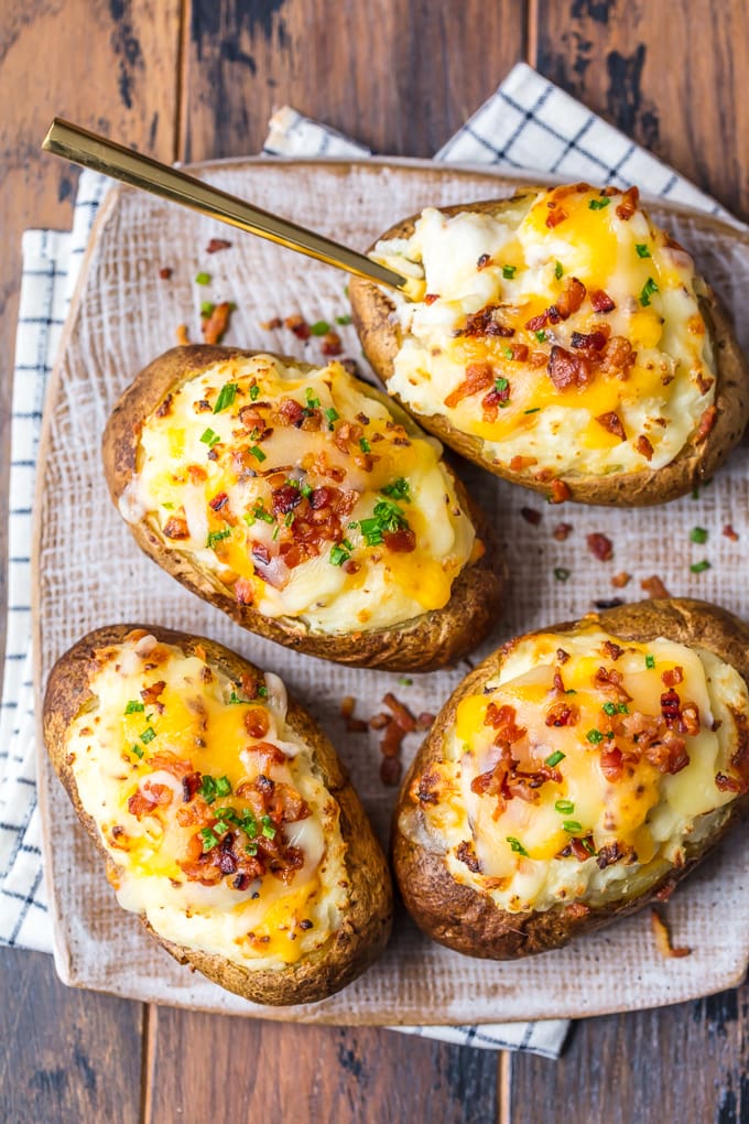  twice baked potatoes topped with cheese, scallions, and bacon