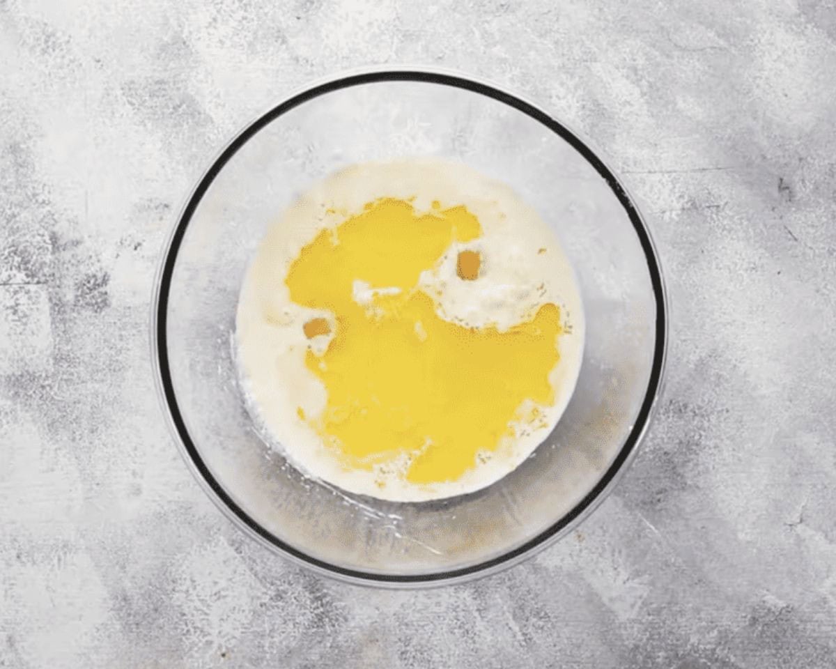 Combining wet ingredients in a glass bowl.