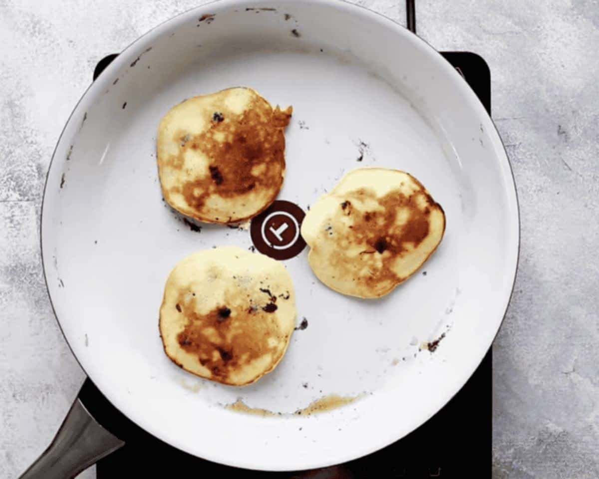 Golden brown pancakes in a skillet.