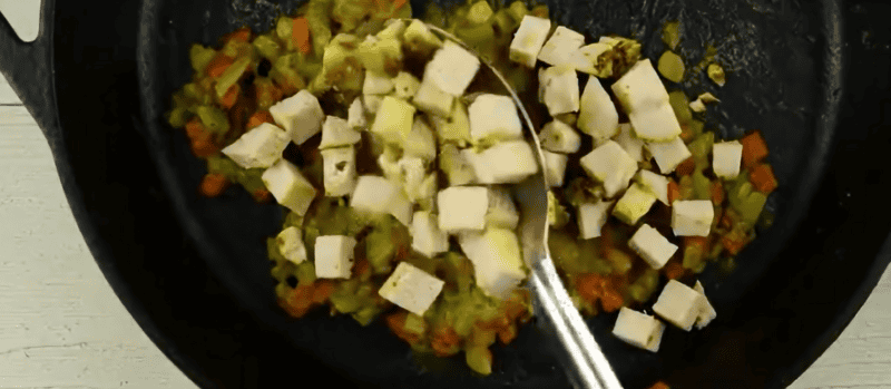 Adding sour cream and chicken to the vegetable mixture.