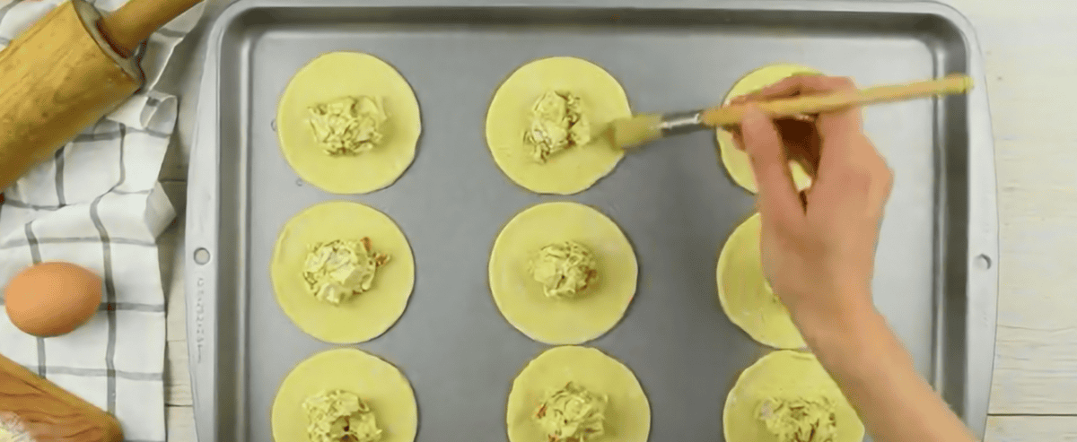 Adding the filling to the hand pies. 