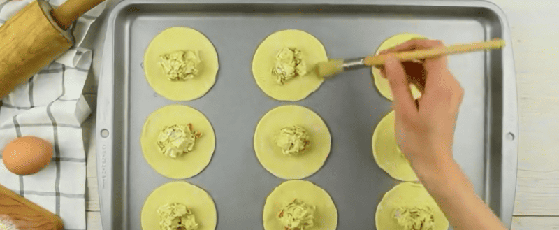 Adding the filling to the hand pies.