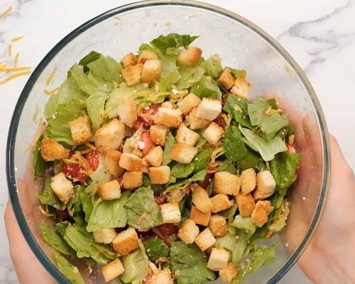 Croutons added to the bowl with the salad. 