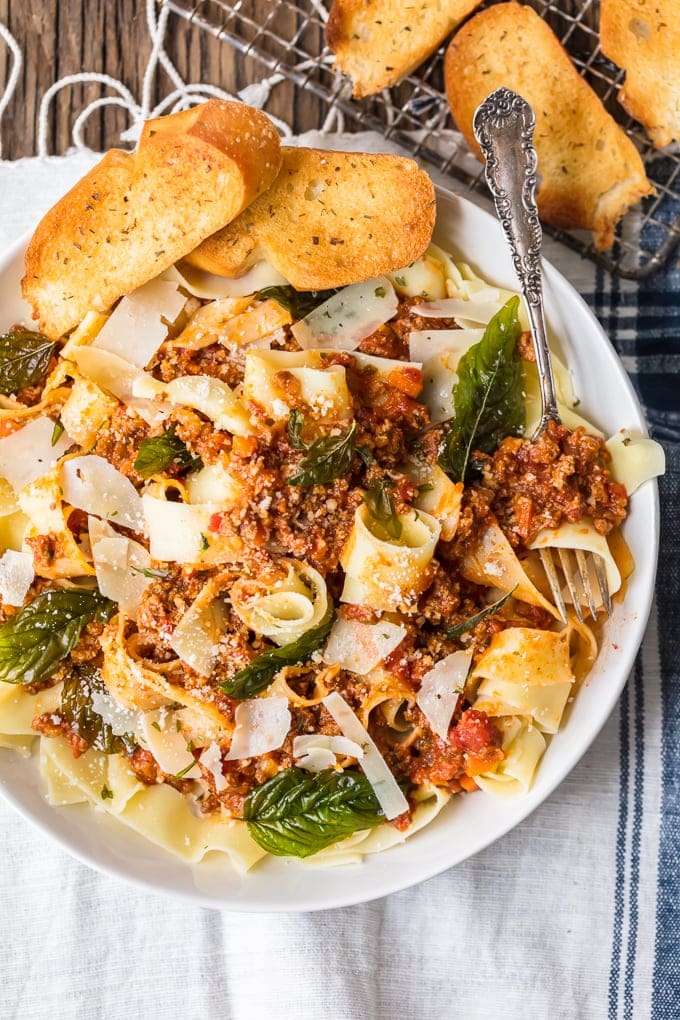 Beef Bolognese is a delicious meat-based sauce served with pasta, and topped with basil and freshly grated cheese. This is the best bolognese sauce recipe outside of Italy! A plate of food, with Beef and noodles
