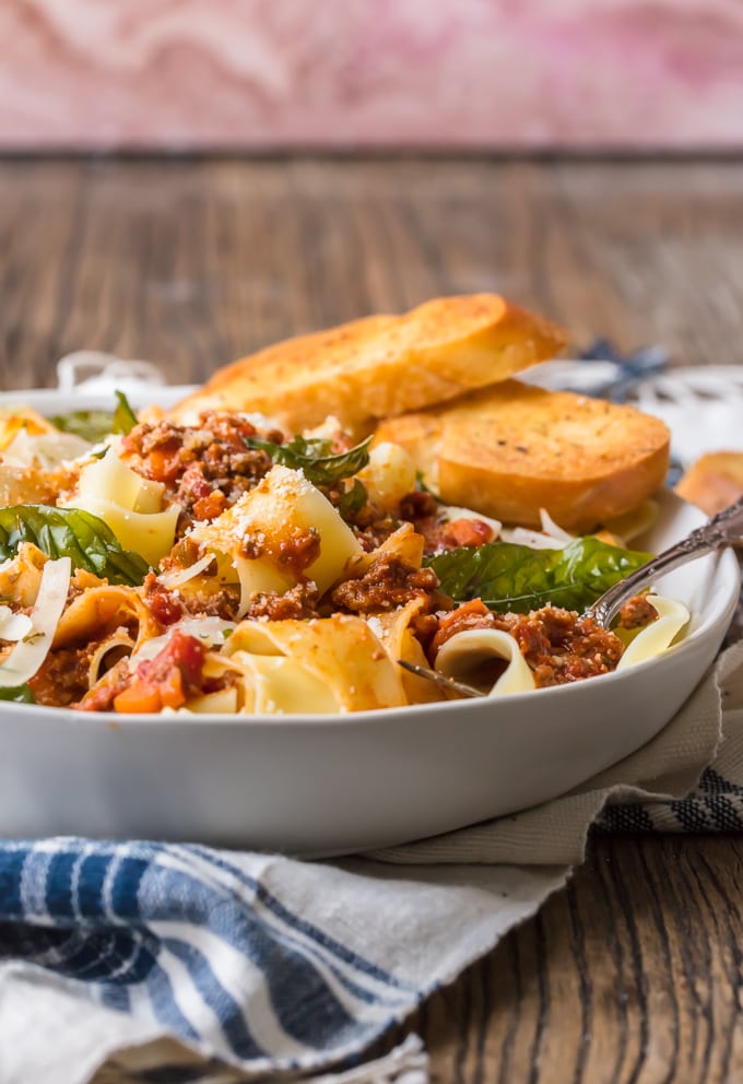 Beef Bolognese is a delicious meat-based sauce served with pasta, and topped with basil and freshly grated cheese. This is the best bolognese sauce recipe outside of Italy! A bowl of pasta bolognese served with bread