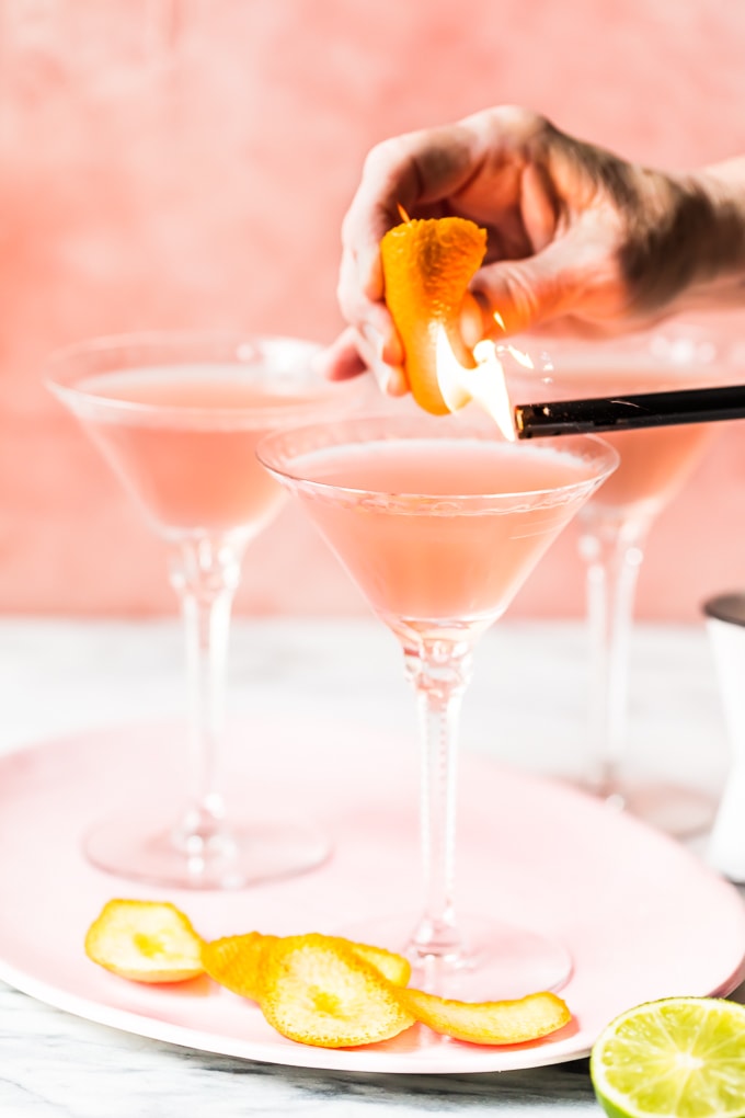Making a flamed orange peel for a cosmopolitan cocktail