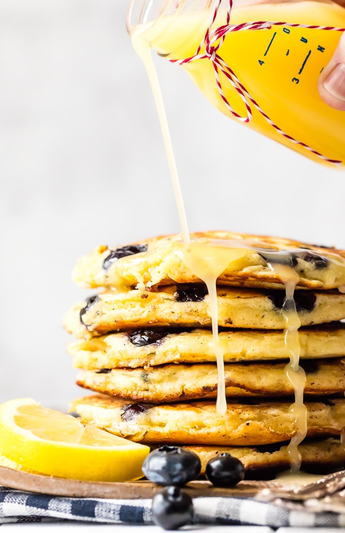 A stack of pancakes covered in lemon sauce
