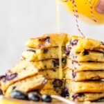 Blueberry Pancakes just might be the most comforting breakfast ever. It's hard not to think of weekend mornings at home with the family when chowing down on pancakes, and that's exactly what this recipe is for! If you want o know how to make blueberry pancakes, it's simple! This is a classic blueberry pancake recipe, light, fluffy, and fruity. And to top it all off, there's a tasty homemade Lemon Sauce to pour on top!