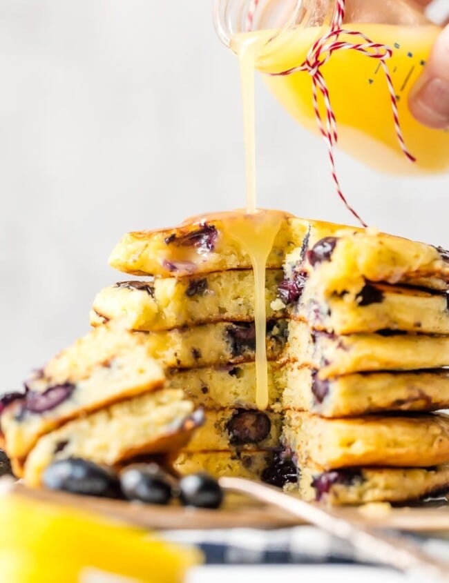 Blueberry Pancakes just might be the most comforting breakfast ever. It's hard not to think of weekend mornings at home with the family when chowing down on pancakes, and that's exactly what this recipe is for! If you want o know how to make blueberry pancakes, it's simple! This is a classic blueberry pancake recipe, light, fluffy, and fruity. And to top it all off, there's a tasty homemade Lemon Sauce to pour on top!