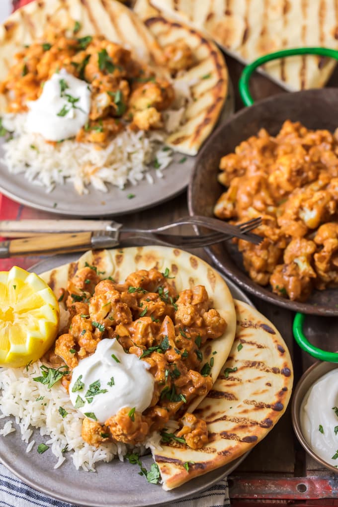 Plates of cauliflower masala, basmati rice, and naan